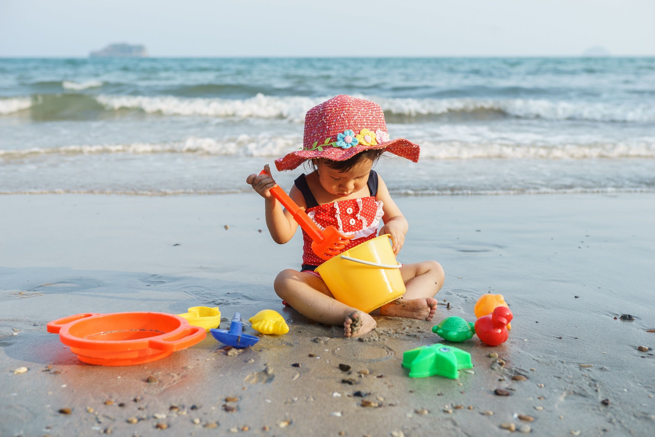 Beach baby with toys